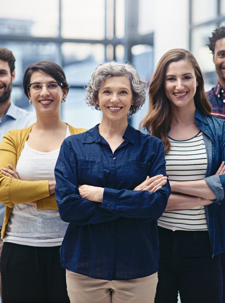 Portrait of a group of creatives standing with their arms folded in the office.