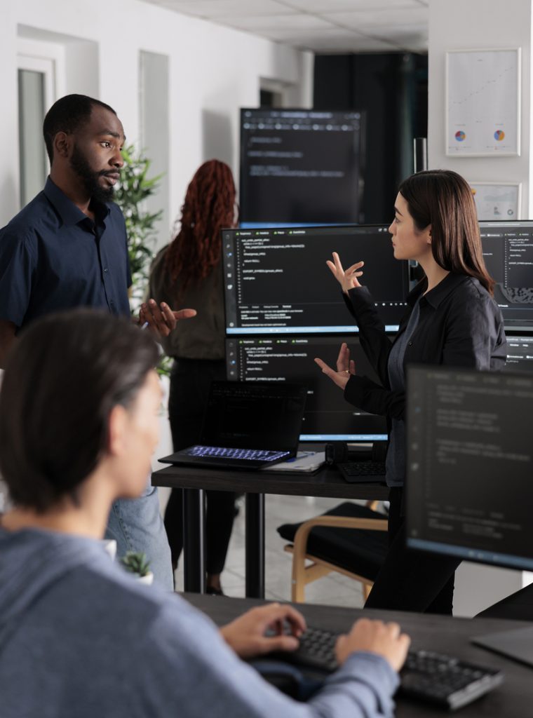 Software developer programming source code algorithm on computer, typing sever data in agency office. Database programer working on new user interface with online system to create algorithm.